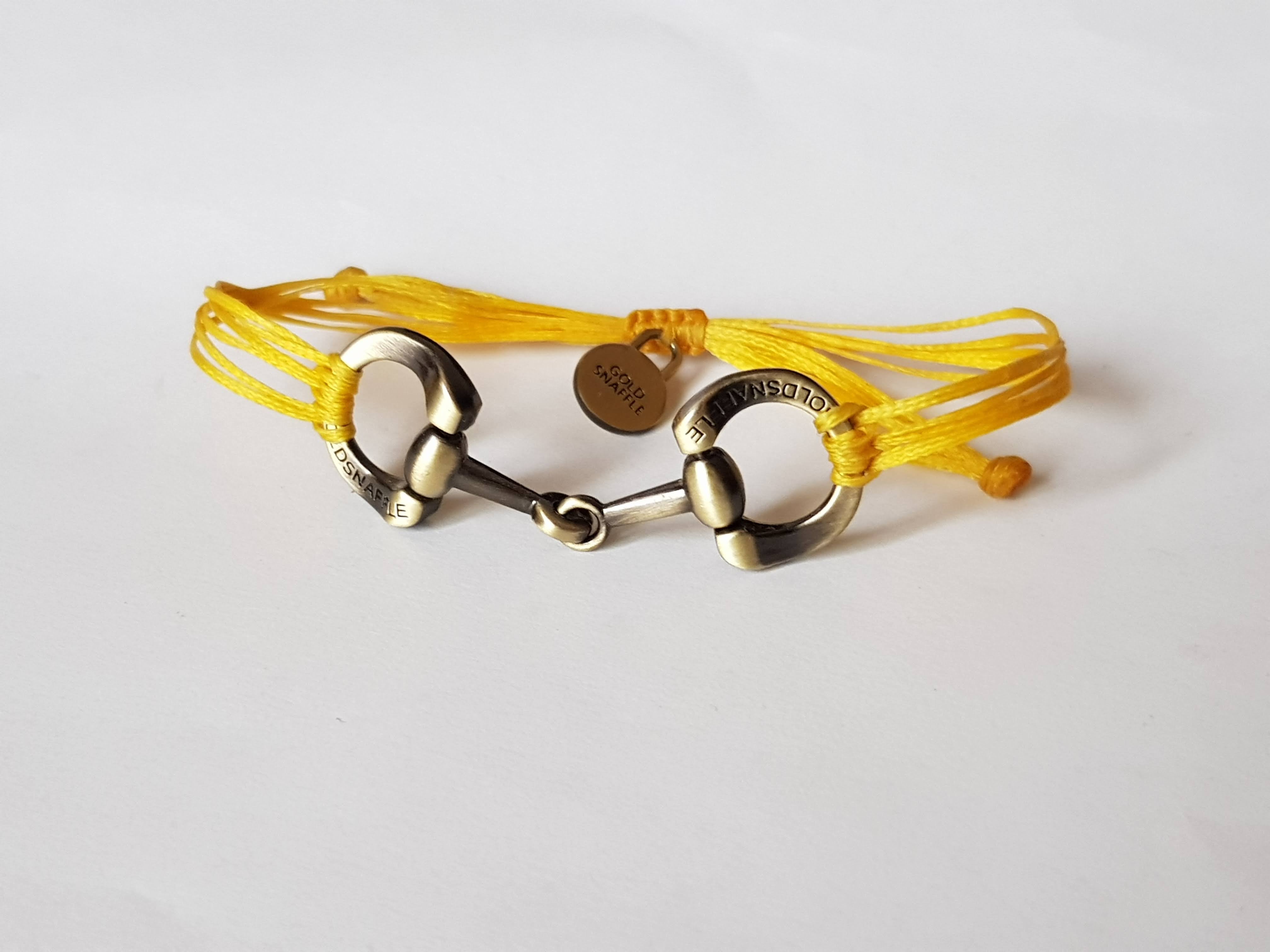 Brushed gold horse bit snaffle bracelet in leather string