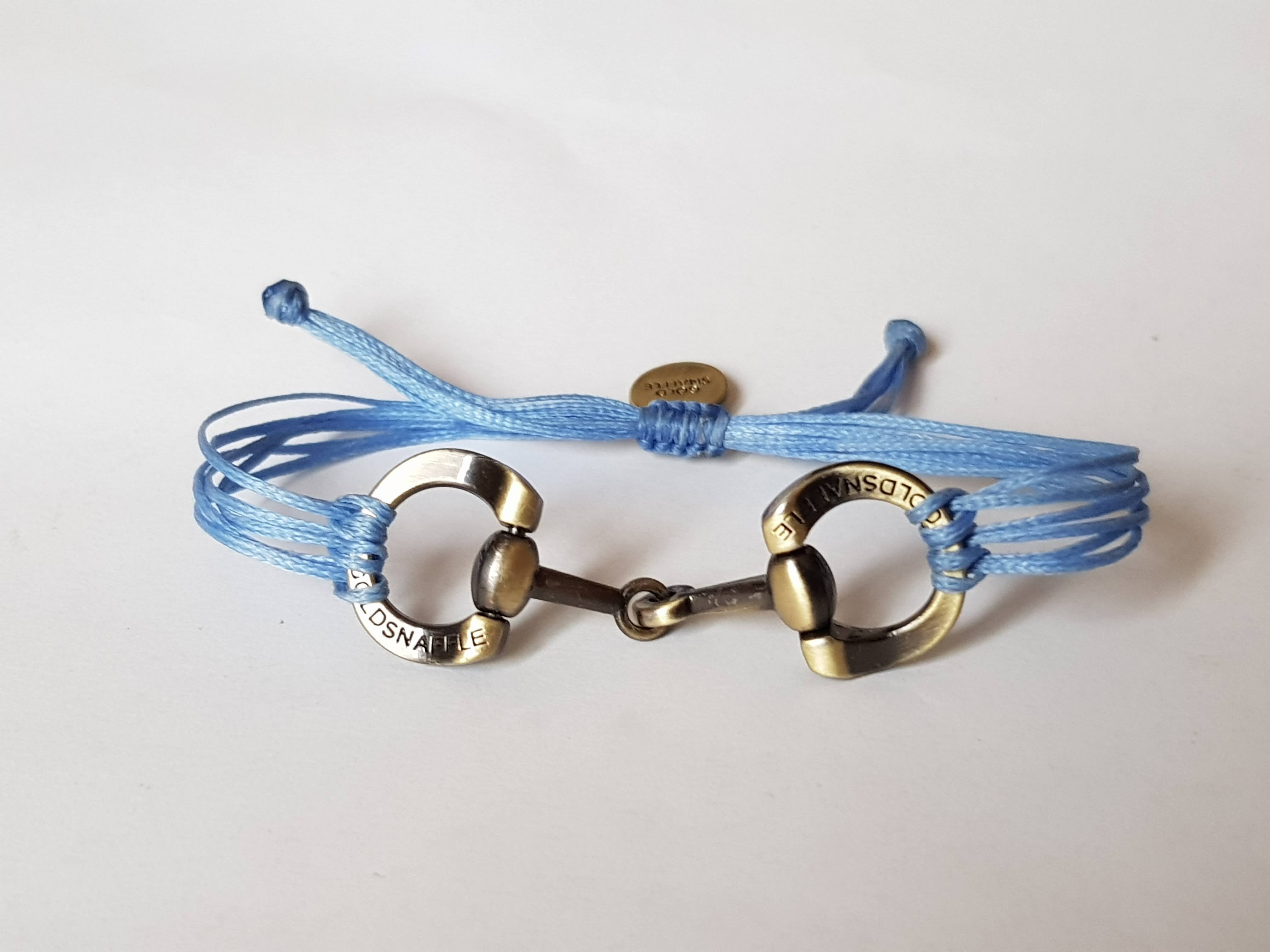 Brushed gold horse bit snaffle bracelet in leather string