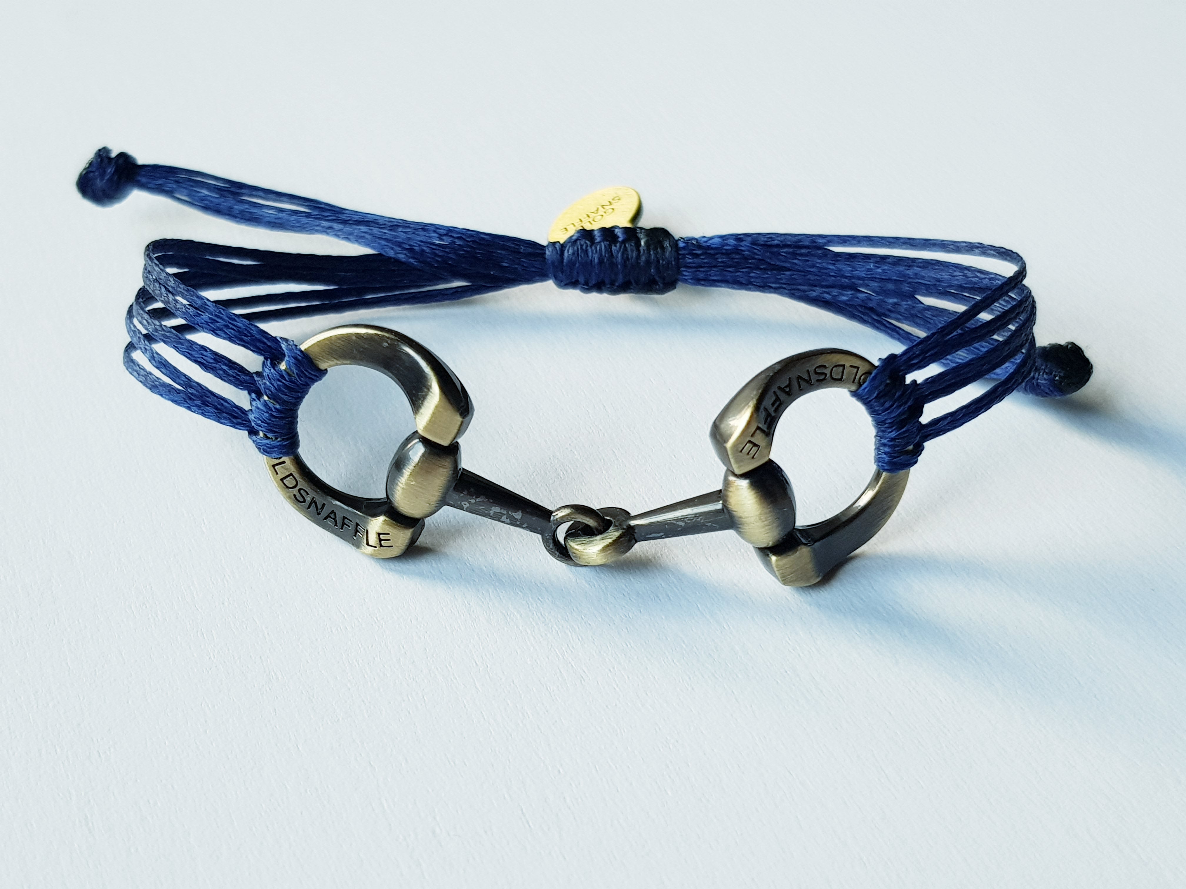 Brushed gold horse bit snaffle bracelet in leather string